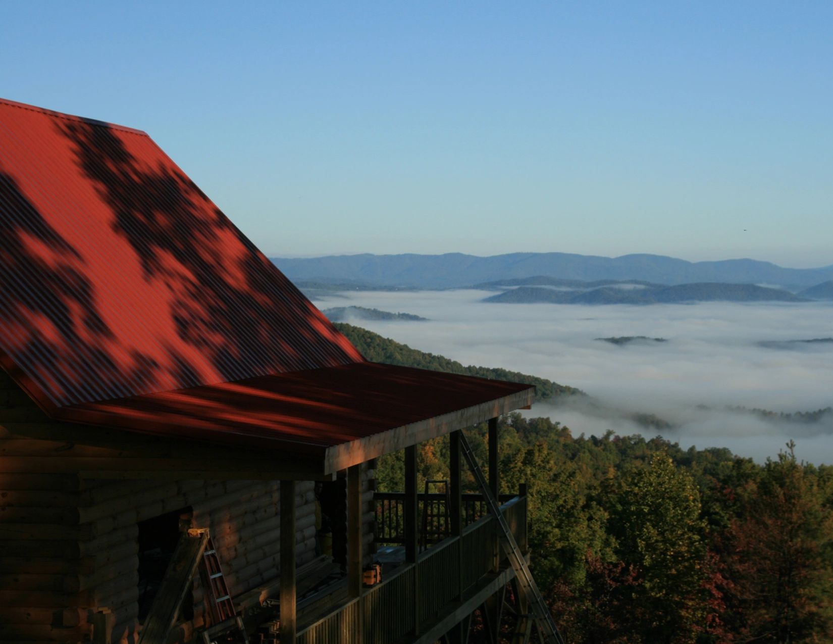 Cabin overlooking mist-filled mountains in the Majestic Mountain development